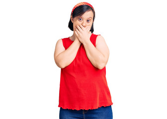 Brunette woman with down syndrome wearing casual clothes shocked covering mouth with hands for mistake. secret concept.
