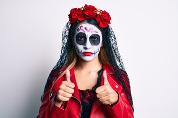 Woman wearing day of the dead costume with thumbs up doing ok sign skeptic and nervous, frowning upset because of problem. negative person.