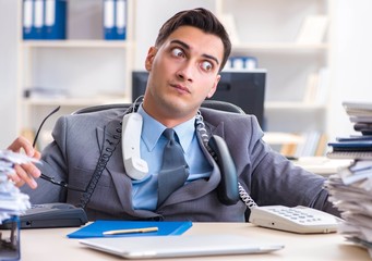 Desperate sad employee tired at his desk in call center