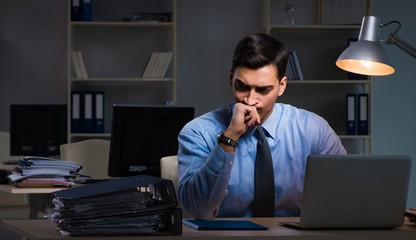 Employee working late at night at important report