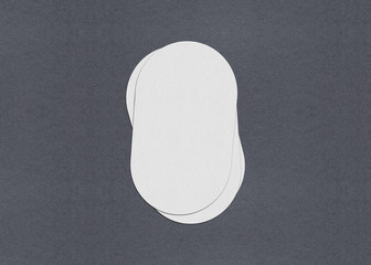 Blank white Business card mockup stacks on grey textured paper background.