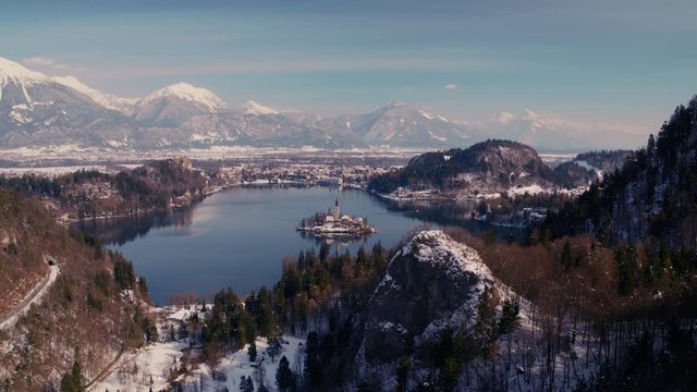 Idyllic drone shot of a lake Bled with a famous church on a small island in winter.