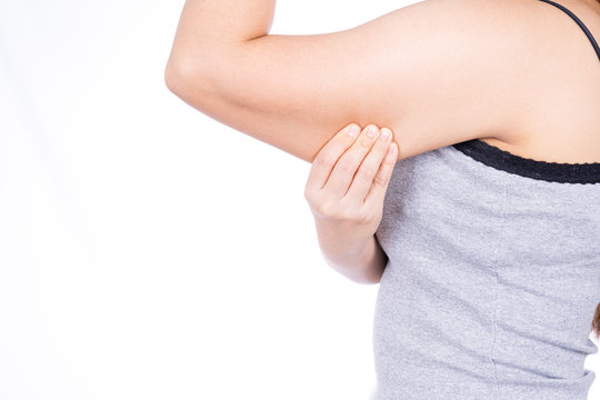 Woman holding excessive fat arm isolated on over white background. Woman pinching arm fat flabby skin. Weight loss, slim body, healthy lifestyle concept.