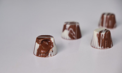 dark chocolate, milk chocolate and white chocolate bonbons. filled with peanut butter, dulce de leche, condensed milk and hazelnut cream