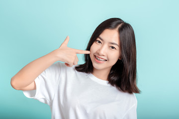 Fototapeta premium Dental braces of young asian woman wearing braces with white teeth concept.
