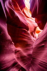 Art of natural scenery in Lower Antelope Canyon in Page Arizona with bright sandstones stacked in flaky fire waves in a narrow sandy labyrinth with caves