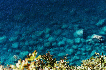 Rich tropical sea with clear blue water. Photo of the ocean with rocks, view from above.