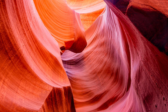 Colorful unsurpassed art of natural landscapes in Lower Antelope Canyon in Page Arizona with bright sandstones stacked in layered fire waves in a narrow sandy labyrinth with caves