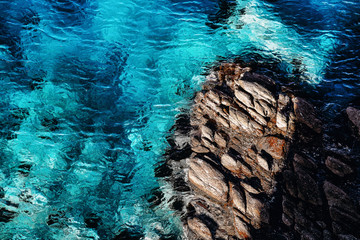 Bright summer background with blue tropical sea and rocks. Transparent sea - the perfect backdrop...