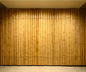 background and texture of decorative yellow bamboo wood on finishing wall surface.