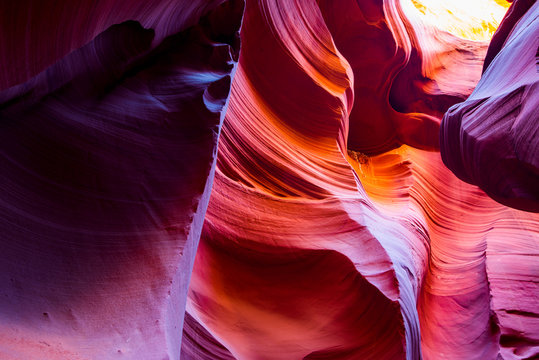 Natural landscapes of vibrant sandstones stacked in flaky fire waves in a narrow sandy labyrinth in Lower Antelope Canyon in Page Arizona