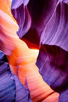 Temperature contrast of the natural landscape of Lower Antelope Canyon in Page Arizona with bright sandstones stacked in flaky fire waves in a narrow sandy labyrinth with caves