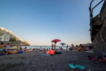 People relax on the city beach of Amalfi in Italy