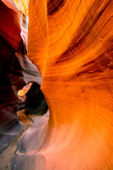 Whimsical labyrinth with undulating walls washed in a sandy gorge in Lower Antelope Canyon in Page Arizona