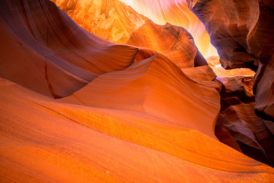Workshop of the Natural Landscape Creator of Lower Antelope Canyon in Page Arizona with bright sandstones stacked in flaky fire waves in a narrow sand maze with caves