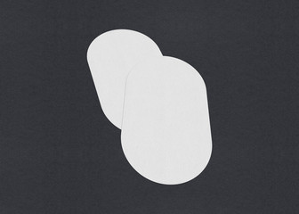 Blank white Business card mockup stacks on grey textured paper background.