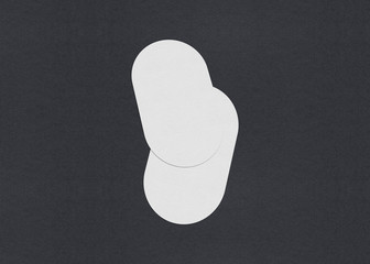 Blank white Business card mockup stacks on grey textured paper background.