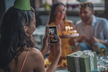 Friends taking pictures during the birthday party