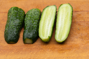 Cucumbers cut in half. on a wooden background