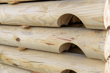 .Wooden balk, timber, beam, stacked at construction site. Wooden planks, lining, boards for construction works in the sawmill. Construction of a wooden house.