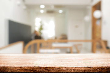 coffee shop blurred background with empty wooden desk montage.