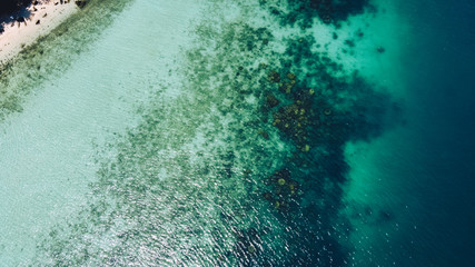 Clear water on the island,Bright blue sea and wooden boat The tourism