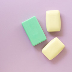 Flat lay of various soap bar on a lilac background