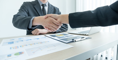 shaking hands, Two business leaders talk about charts, financial graphs showing results are analyzing and calculating planning strategies, business success building processes