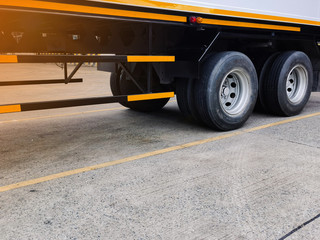 Freight container truck parking at loading dock for load shipment carton boxes and goods from warehouse cargo storage in logistics and transportation industrial