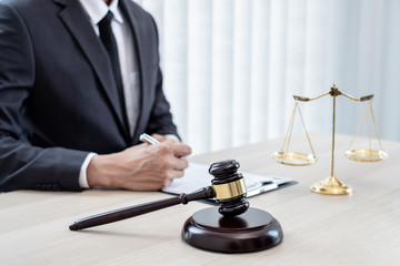 Fototapeta na wymiar Judges gavel, Professional male lawyers work at a law office There are scales, Scales of justice, judges gavel, and litigation documents. Concepts of law and justice