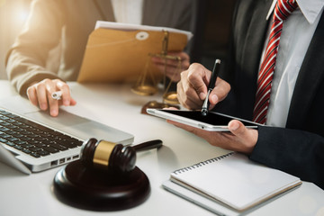 Business people and lawyers discussing contract papers sitting in the table at office in the...