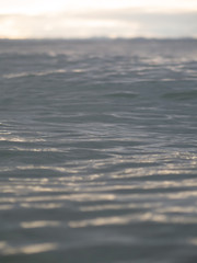 Small waves breaking on a surf beach, New Zealand. 