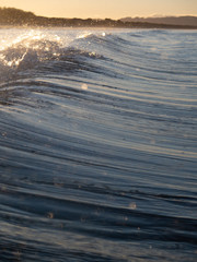 Small waves breaking on a surf beach, New Zealand. 