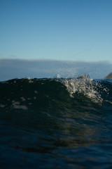 Fototapeta na wymiar Small waves breaking on a surf beach, New Zealand. 
