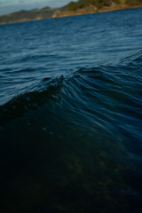 Small waves breaking on a surf beach, New Zealand. 