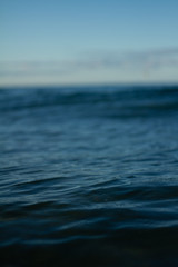 Small waves breaking on a surf beach, New Zealand. 