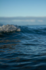 Small waves breaking on a surf beach, New Zealand. 