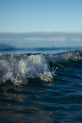 Small waves breaking on a surf beach, New Zealand. 