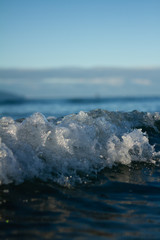 Small waves breaking on a surf beach, New Zealand. 