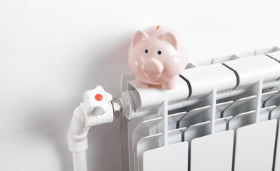 Piggy bank on radiator. Energy saving