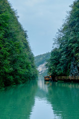 Zhangjiajie Grand Canyon, Hunan, contains mountain streams, silk-like smooth water, birds playing in the water, aquatic plants, ossy stones, cliffs, green trees environment, blue sky and reflection as