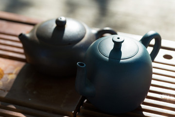 Chinese tea ceremony. Ceramic teapot made of clay and bowls on a wooden background.