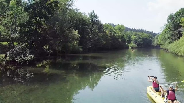 River kayaking under an old wooden bridge on Kolpa river in Slovenia. 4K