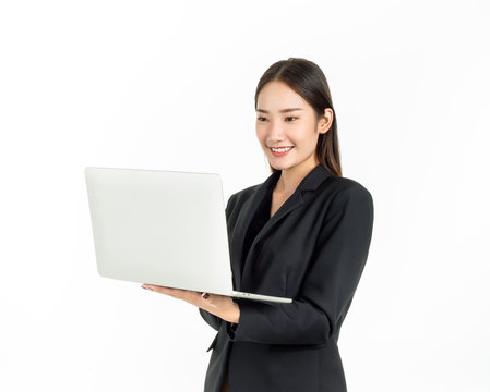 Asian smiling business women wearing suit using laptop computer isolated on white background.