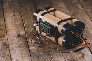 Bomb with timer on wooden background