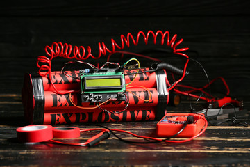 Bomb and tools on table against dark background