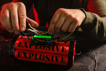 Man defusing bomb at table, closeup