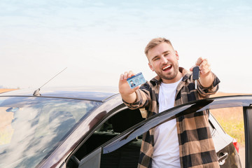 Happy young man after successful passing of driving license test