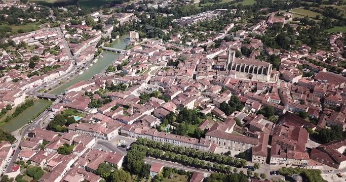 Aerial view of Condom cityscape on banks of Baise river overlooking Catholic cathedral, France