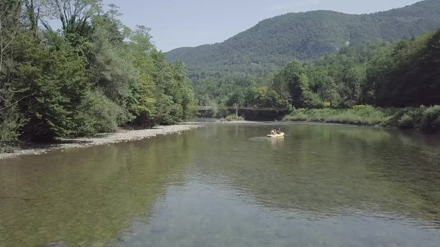 River kayaking under an old wooden bridge on Kolpa river in Slovenia. 4K